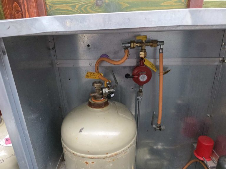 Gasflasche mit Druckregler und Schlauchleitung im Flaschenkasten eines Foodtrucks – Gasprüfung nach DGUV 110-010